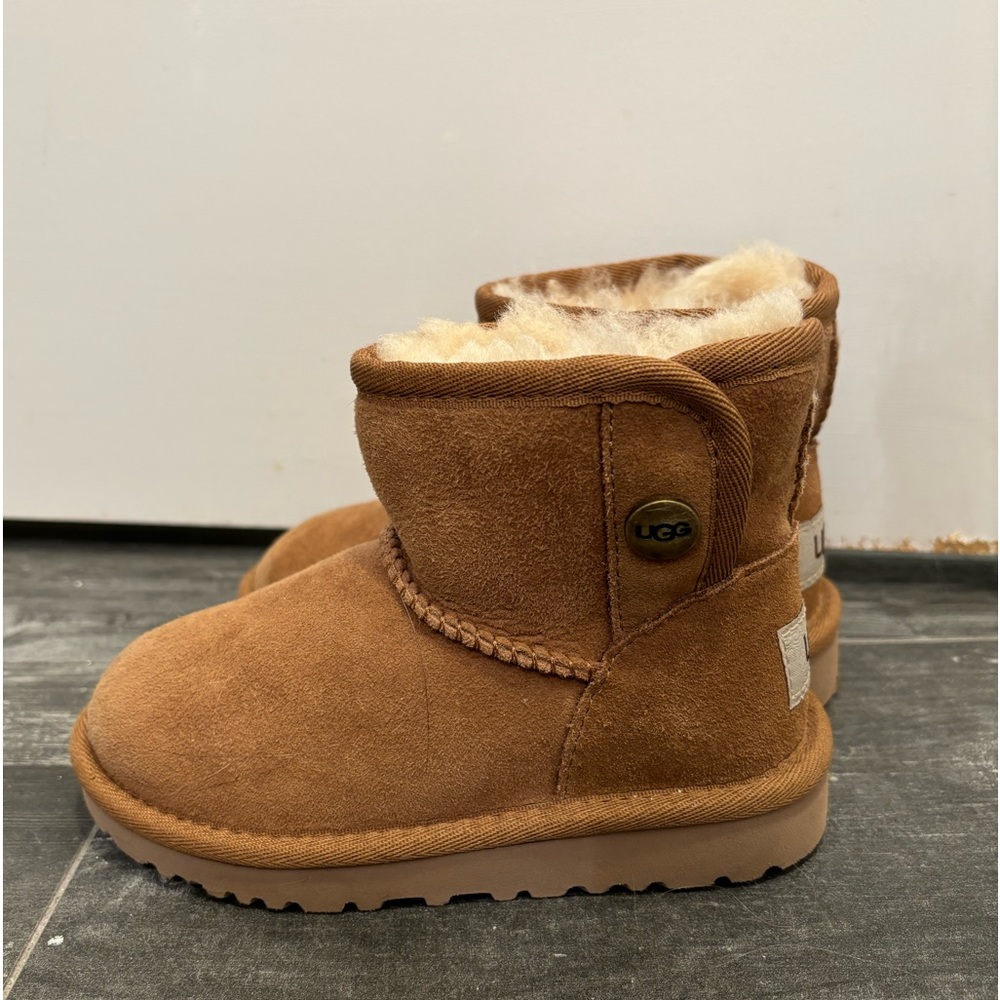 Never worn toddler Ugg boots with snap. Size 9 toddler